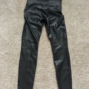 Black faux leather leggings with zipper detail